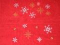 A Christmas Towel Witih Stars, Snow Flakes Embroidered On It.