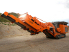 Mobile Mounted Crusher - Steel 9.60m x 2.50m x 3.20m Orange | Adjustable Settings Hydrostatic Drive Remote Control High Capacity 200 Tons/H