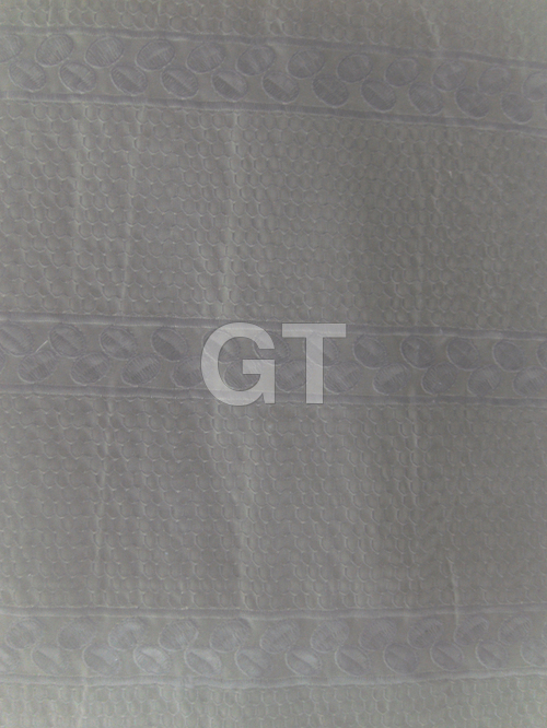 Fine white embroidery on white fabric