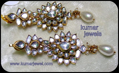 white kundan earrings.