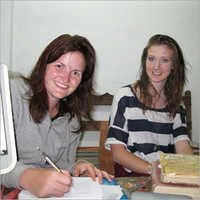 Visitors Writing Comments On Visitors Book
