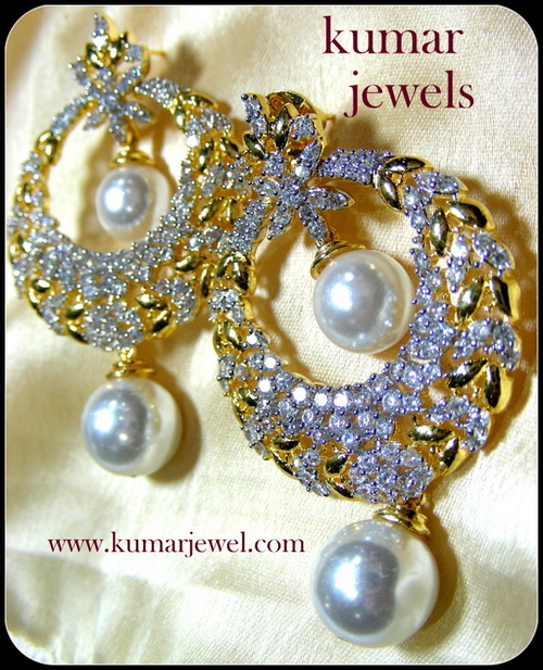 White emblem earring.