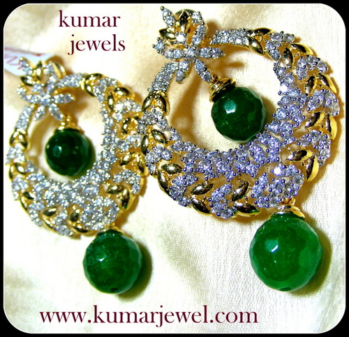 Emblem drop earring.