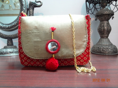 brocade bag with pompon tassel
