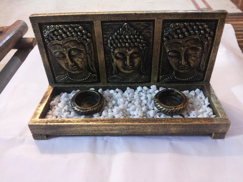 Buddha faces with tea-lights