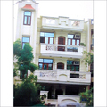 Vivek-Vihar-Delhi - Concrete, Brick, Off-White, Three-Story Residential Building, Two Balconies, Durable Structure