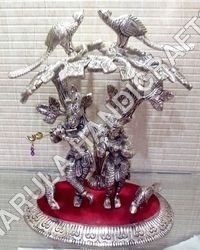 white-metal-radha-krishna-statue-under-tree
