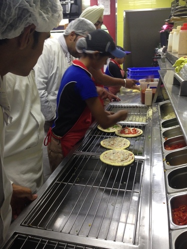 nfci students learning to prepare pizza