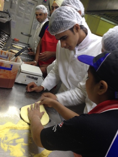 nfci students learning to prepare pizza