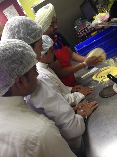 nfci students learning to prepare pizza