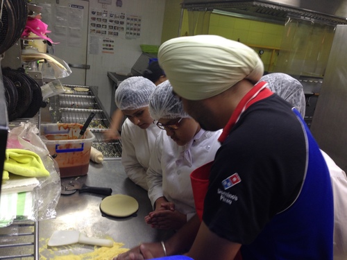 nfci students learning to prepare pizza