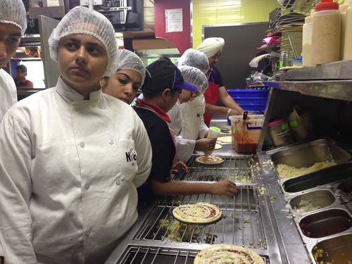 nfci students learning to prepare pizza