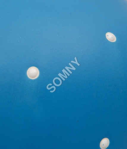 SURFACE OF POLKA DOTS ON BLUE MAT
