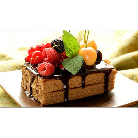 Food Cakes and Sweet Fruits And Berries On A Chocolate Biscuit
