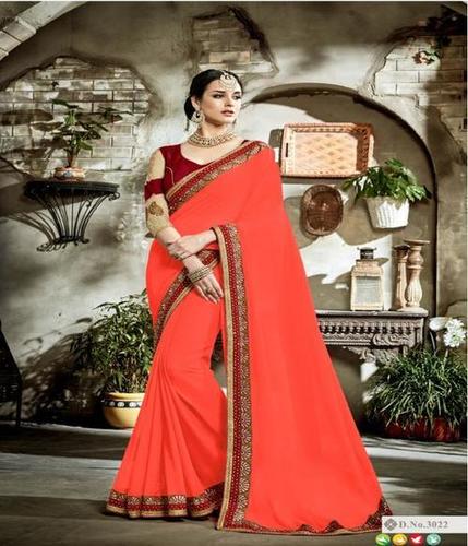 Embroidered Georgette Saree - Orange Color with Lace Border, Comes with Peach Blouse Piece, Perfect for Bollywood Style Occasions