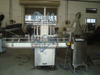 AUTOMATIC FOUR HEAD FILLING MACHINE