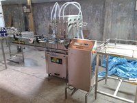 AUTOMATIC SIX HEAD LIQUID FILLING MACHINE