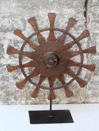 Wooden wheel on iron stand