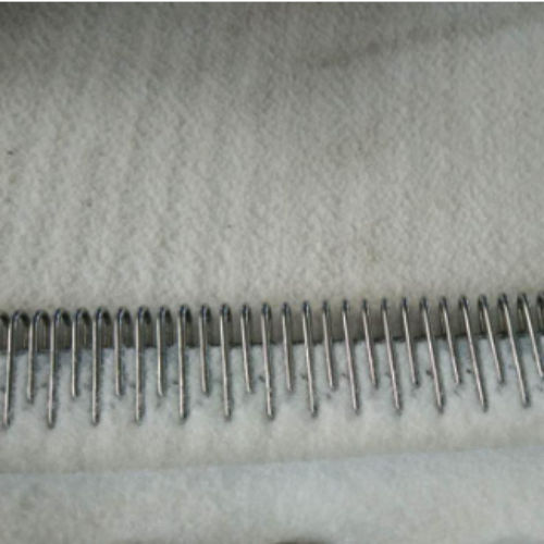 Needle corrugator belt