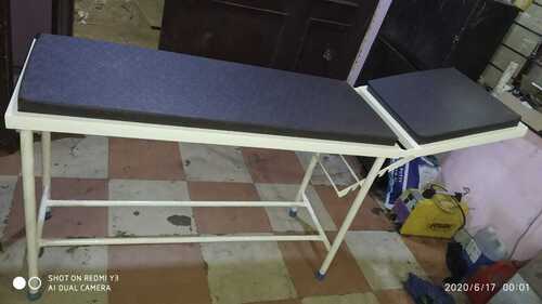 Examination table with cushion top