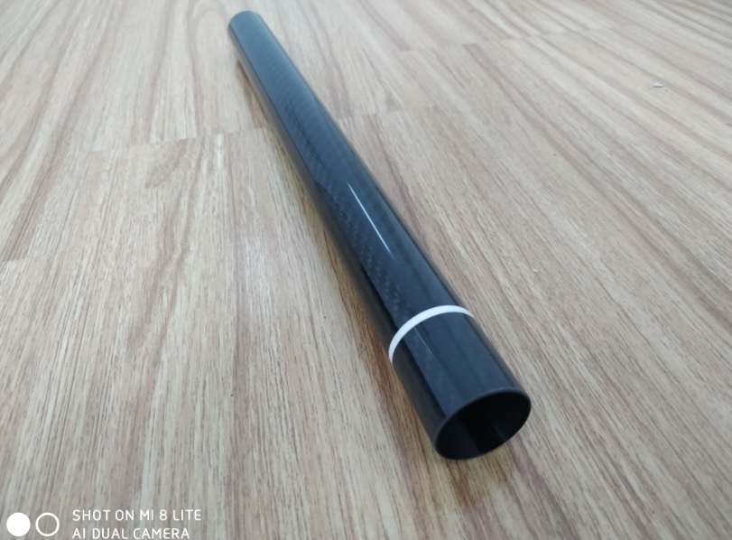 30mm Diameter Roll Wrapped Carbon fiber tubing with white warning tape provided by Chinese factory