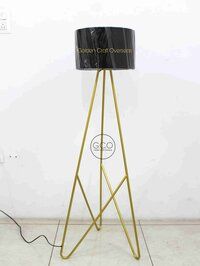 Tripod design floor lamp in iron with black fabric shade