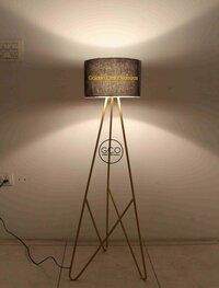 Tripod design floor lamp in iron with black fabric shade