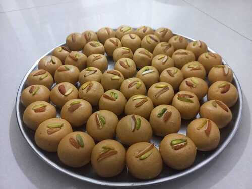Besan Laddu - Food - Besan (Gram Flour) Sugar Ghee Nuts, Small Round Shape, Glossy Golden Brown Finish , Crafted with Traditional Indian Sweet Presentation