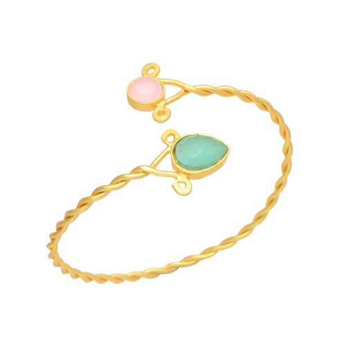 Golden cuff bracelet with pink and green gemstone