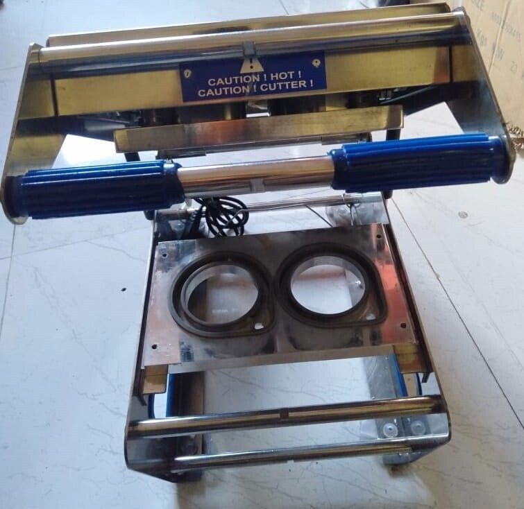 Double cup sealing machine