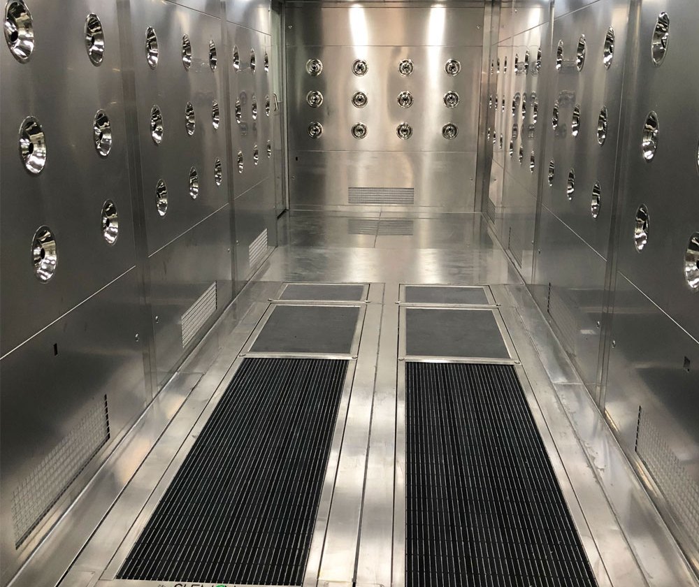 Air shower with shoe sole cleaner
