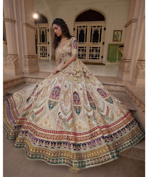 Off-white georgette lehenga choli with hand cut dana and sequins work