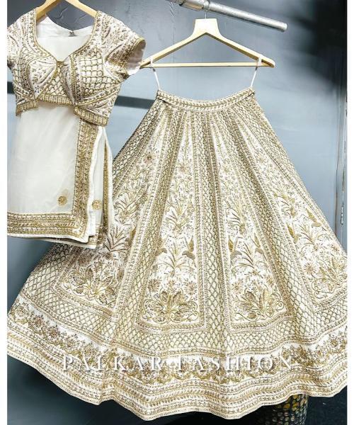 Off-white georgette lehenga choli with hand cut dana and sequins work
