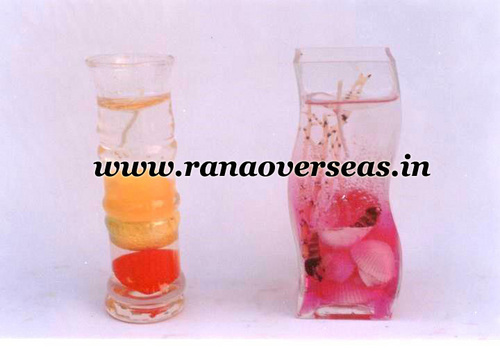 Pink And Yellow Wax Candle In Glass.