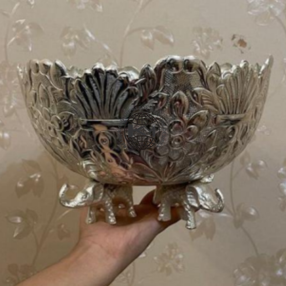 silver decor bowl with elephant-shaped legs.