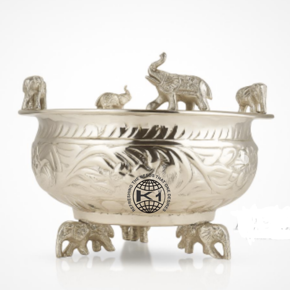 decorative brass Urli bowl with carved legs.