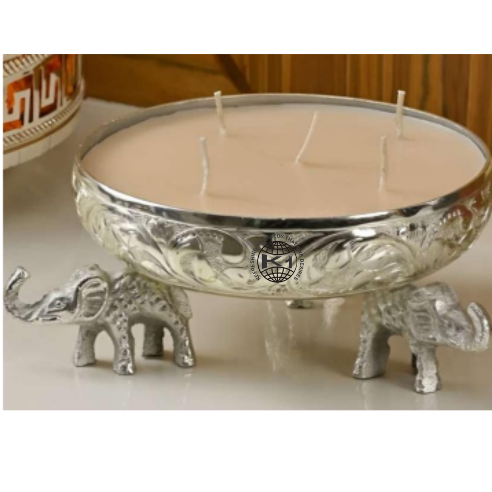 silver-toned metal urli candle with elephant stands. 