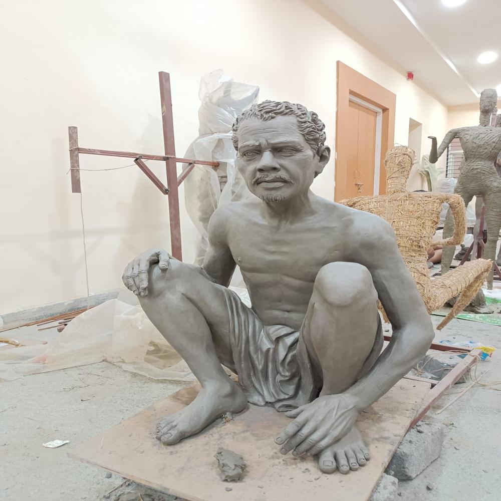 Human figure sitting statue