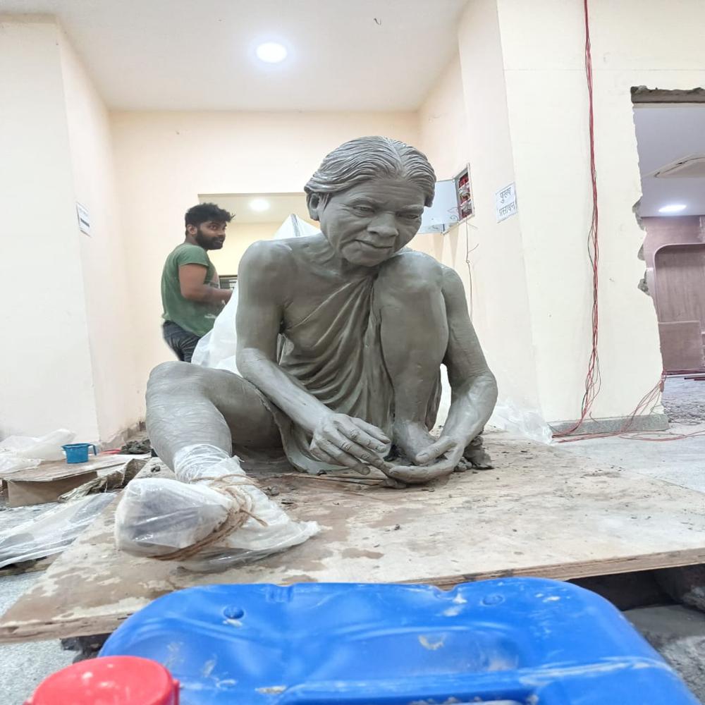 Human figure sitting statue