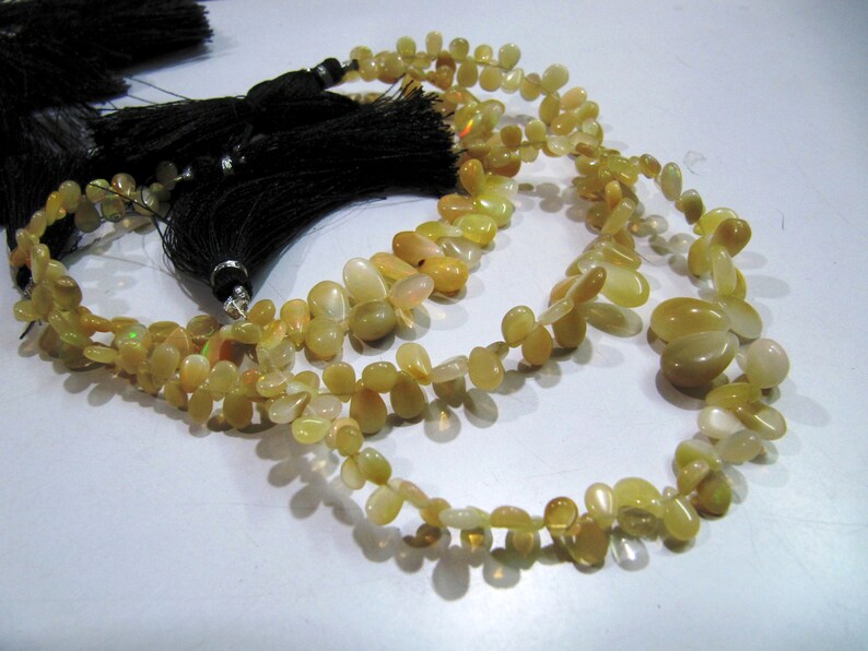 Ethiopian Opal Golden Beads, Flat Drop Smooth Beads Size 4x6mm to 6x9mm, Strand 8 inch Long with approx. 70 beads per strand
