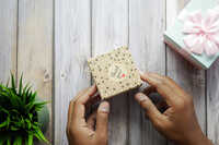Hand Putting Gift Box
