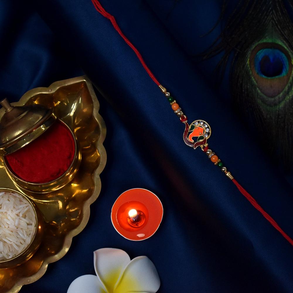 Golden Ganesha Rakhi Red Green Beads With Stone Detailing - Color: Mix