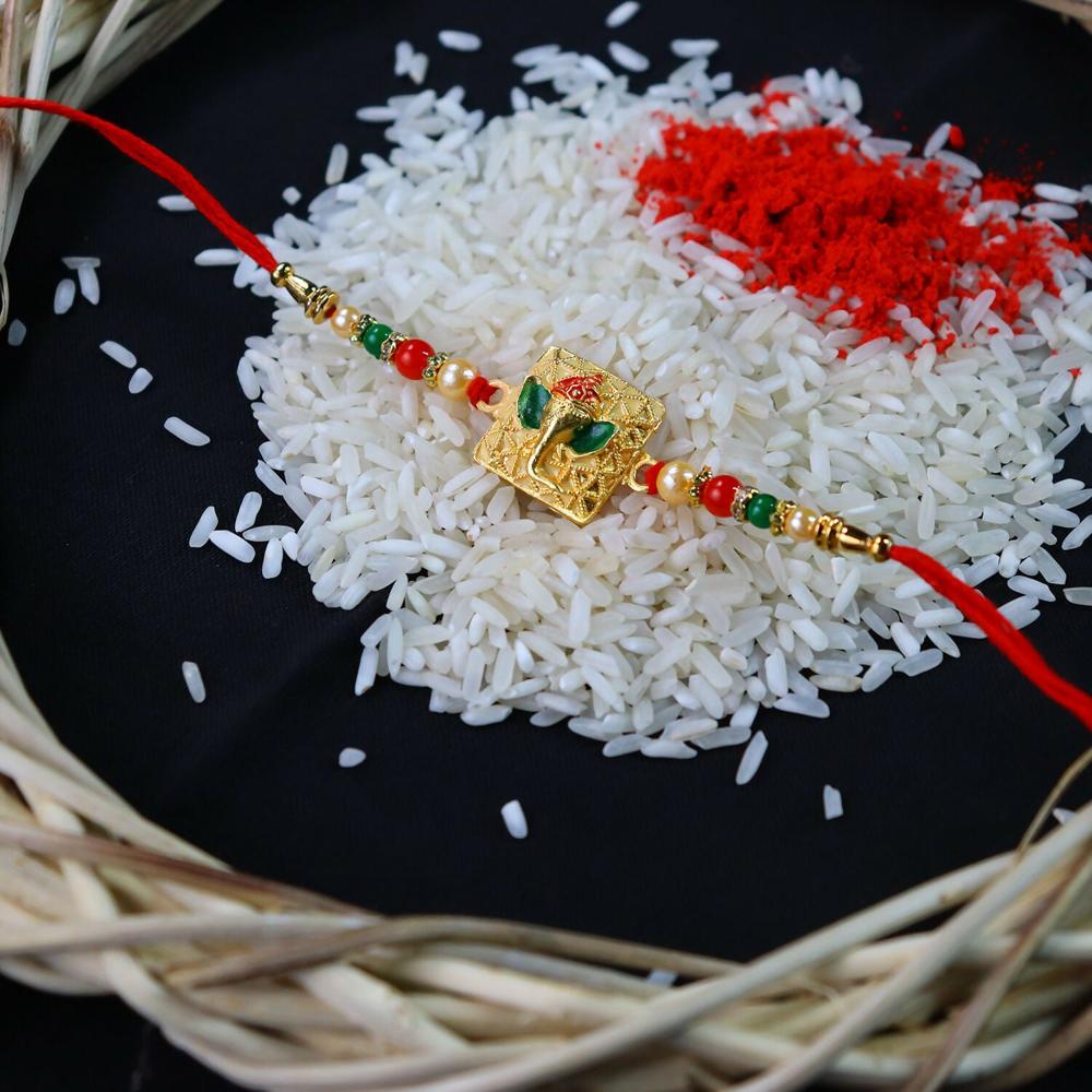 Golden Ganpati Rakhi Red Green Beads with Enamel Detailing