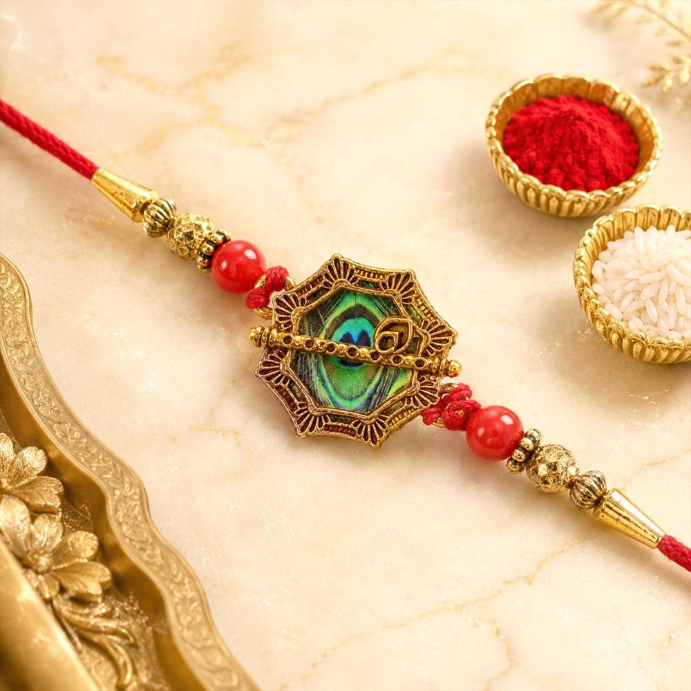 Shop Peacock Feather Rakhi Golden Frame Red Beads