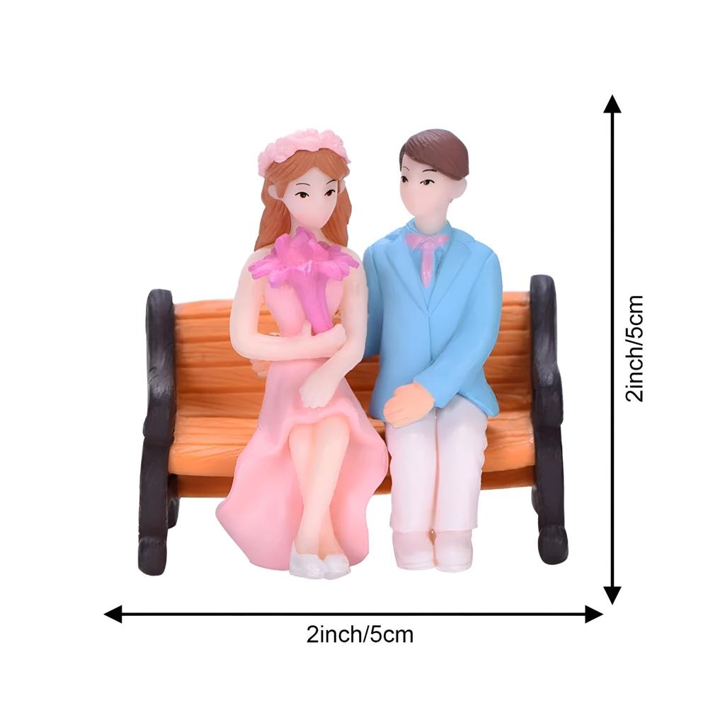 Miniature Couple Sitting On Chair