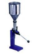 Collapsible tube filling machine 