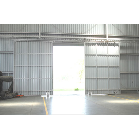 Industrial Sliding Door - Ms Sheet / Gi Sheet, 15-20 Feet Height, Grey Color, Exterior Use, Motorized Option, Designed For Garage And Workshop Applications