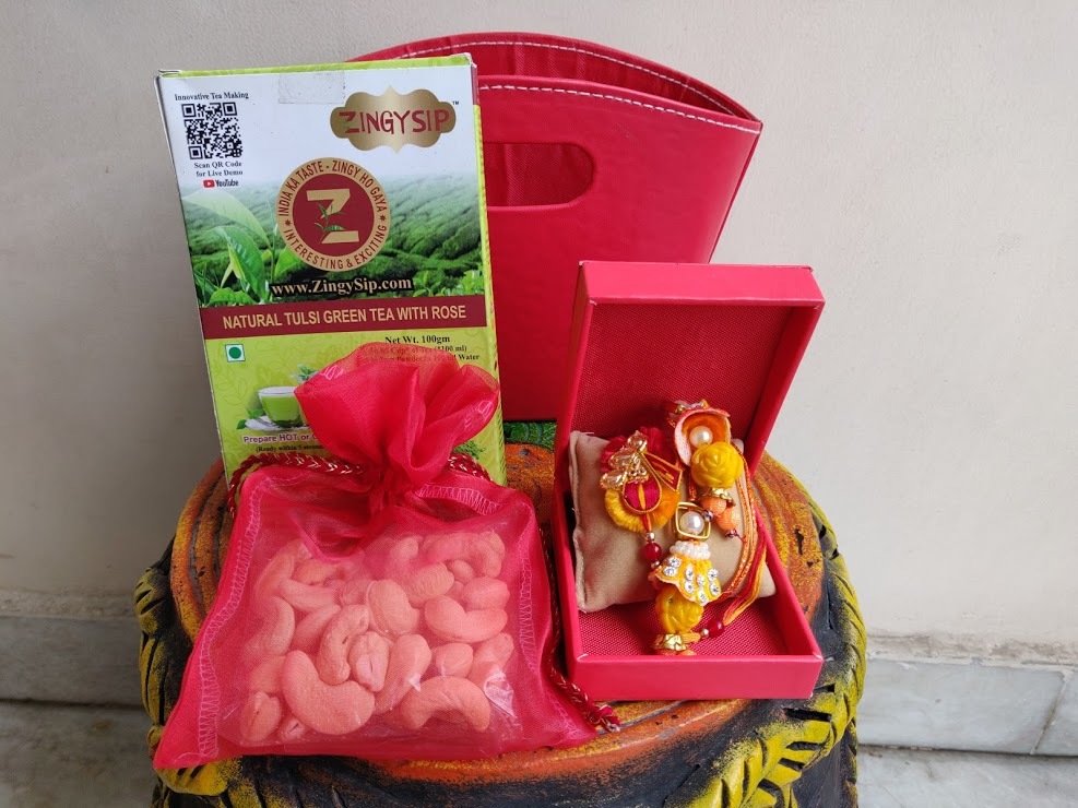 Rakhi Hamper - Multi-material, 6x3x6 Inches, Red Color | Gift Basket Of Joy With Watch Box, Assorted Teas, And Nut Potli
