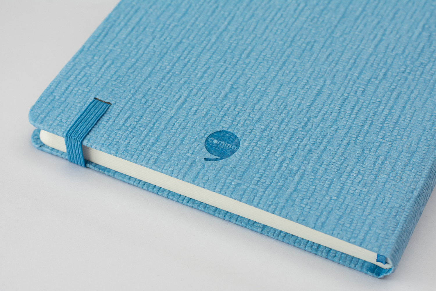 Features Include An Elastic Band Closure Comma Abaca - A5 Size - Hard Bound Notebook (Sky Blue)