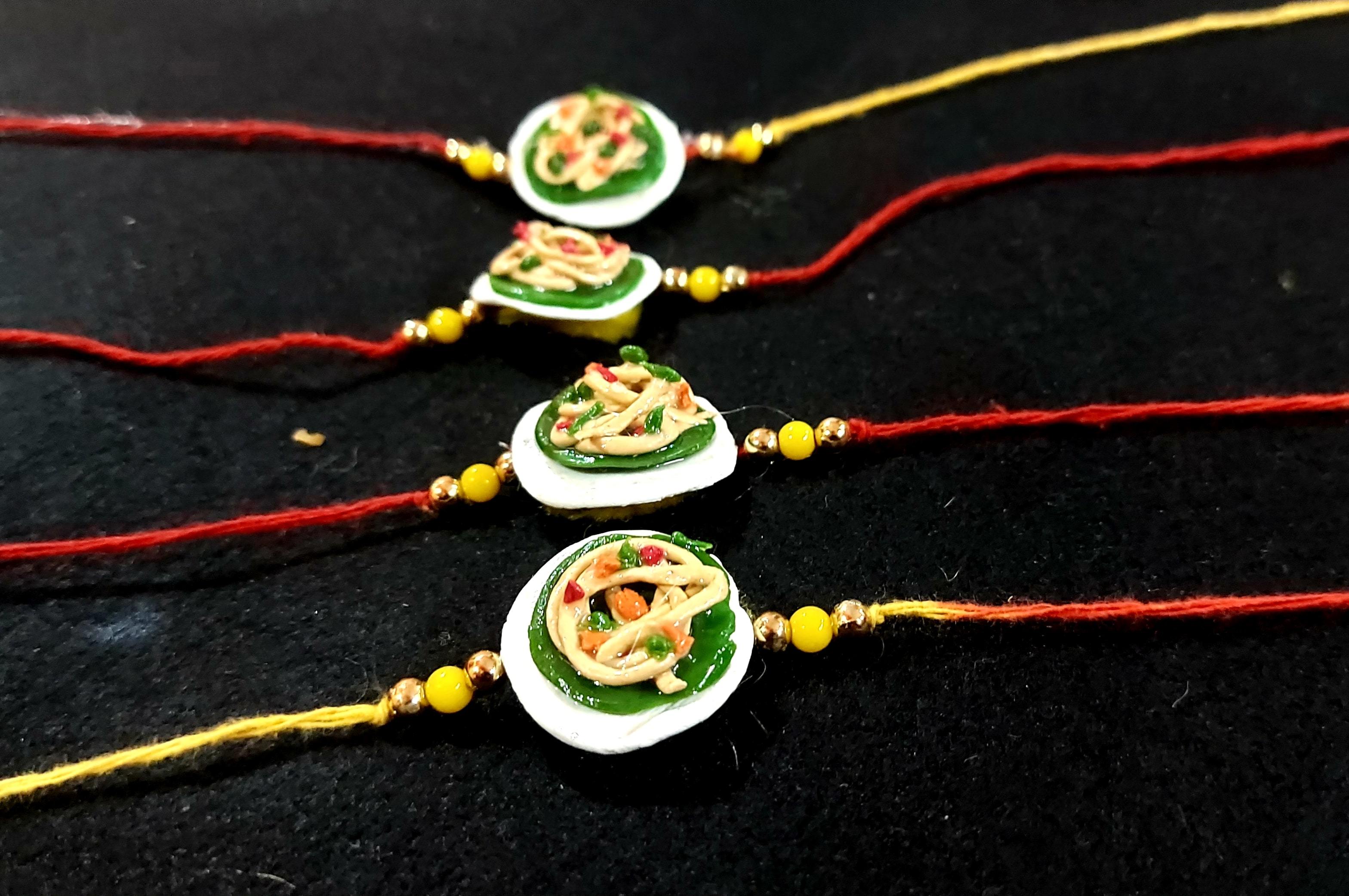 Designer Rakhies - Gold, 2x3 Inches, Red | Handmade Resin Rakhi, Elegant Design, Pearl Accents, Gift Box Packaging, Durable